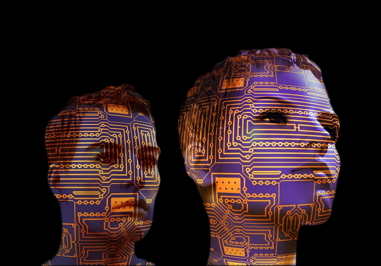 A photo of two heads with circuitry on the face
