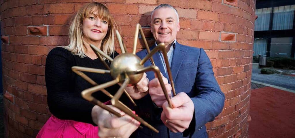 Tracy Carney and Director of B2B Sales of one4all holding a golden Spider award trophy.