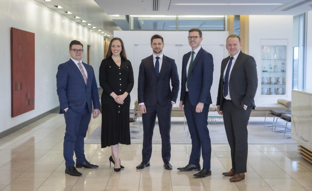 Group photo of Matheson LLP's five newly promoted partners. From left to right: Ruadhán Kenny (Litigation), Susan Carroll Chrysostomou (Corporate M&A), Raphael Clancy (Tax), Connor Cassidy (Litigation), and John Coary (Corporate M&A), posed professionally, symbolizing their recent appointments in various practice areas.