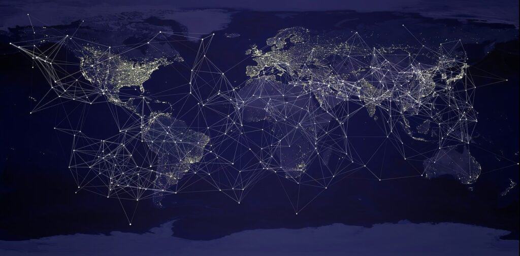 A graphical representation of a global network with interlinked nodes and lines superimposed on a darkened map of the Earth, emphasizing major cities and areas with bright clusters of connectivity