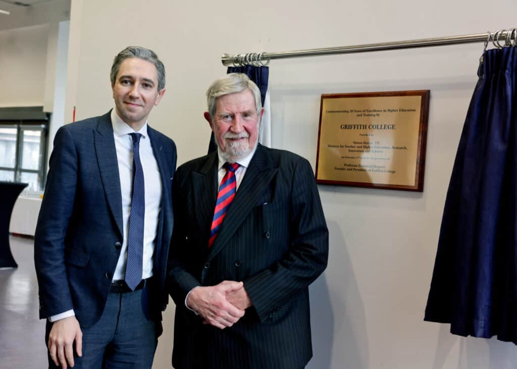 Minister Simon Harris TD and Professor Diarmuid Hegarty, President of Griffith College, stand side by side as they unveil a commemorative plaque, marking the 50th anniversary of Griffith College.