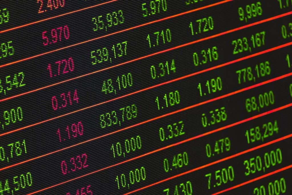 Digital stock market display showing a mix of red and green numbers
